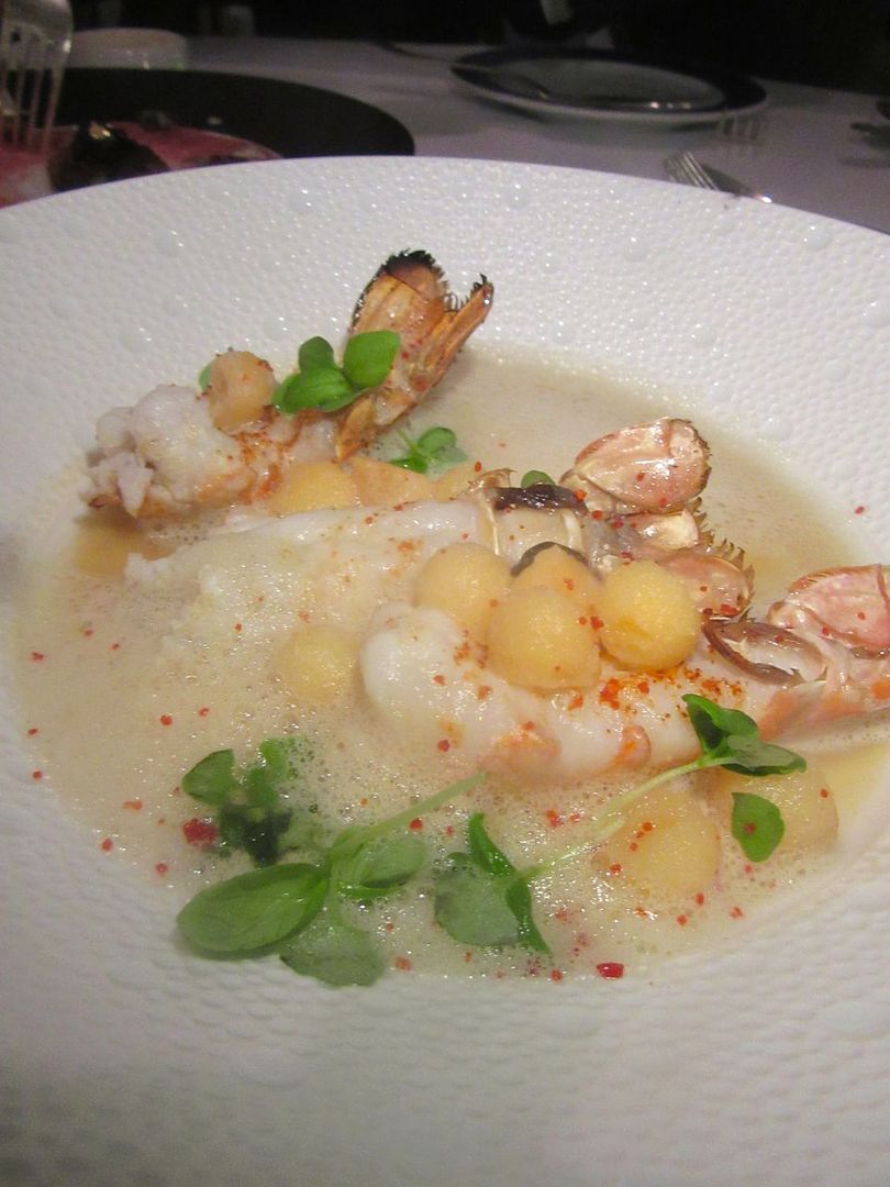 Seared Scottish langoustines with pickled peach balls in a wine broth at Petrossian.