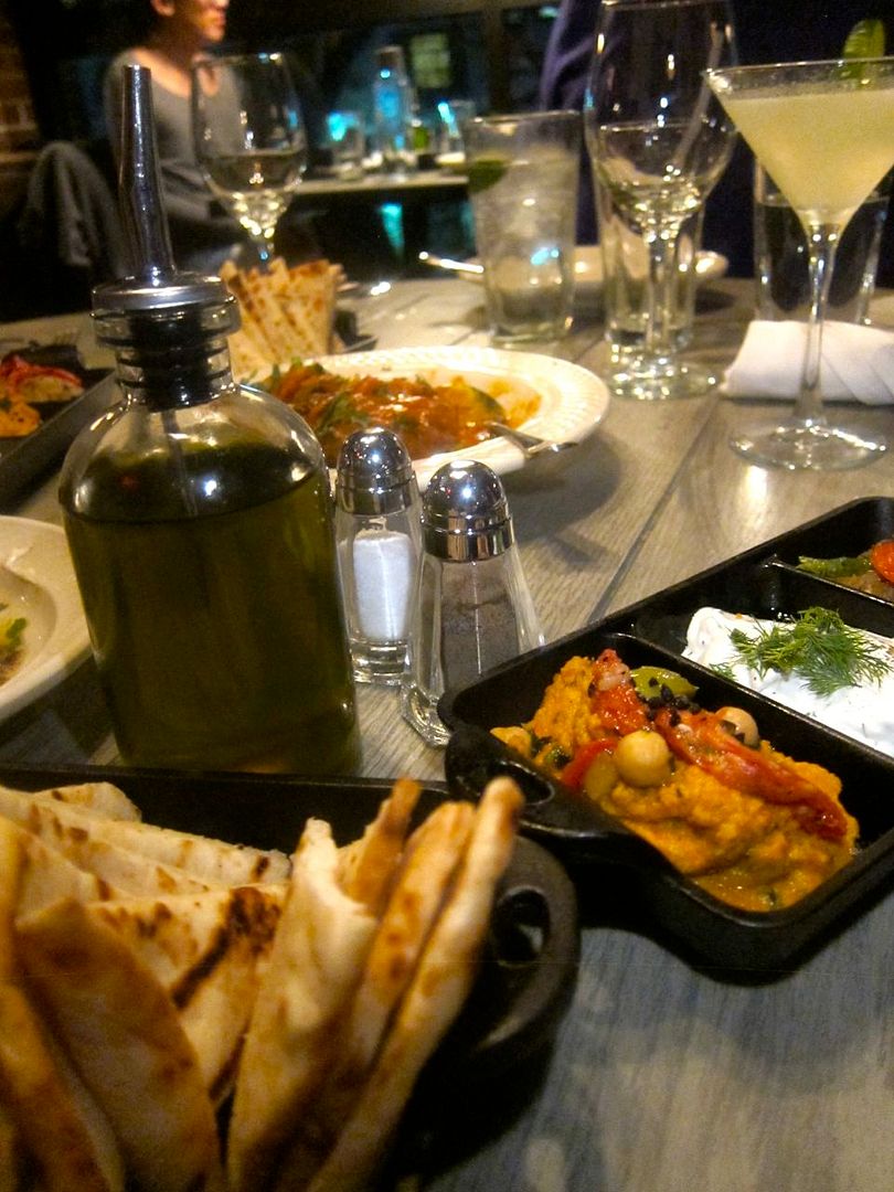 Upstairs in the handsome industrial space, our table is soon crowded with dips and pita.